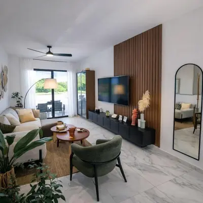 a living room with a couch and a table at Aqua Poolside Serenity Pool & Golf 2B Cana Bay in Punta Cana