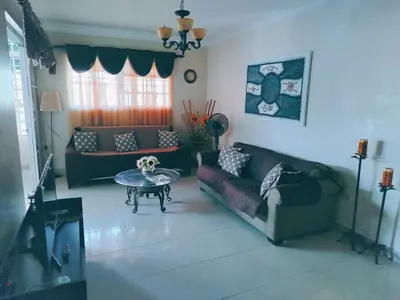 a living room with two couches and a table at Central and spacious, 3-bedroom apartment in Santo Domingo in Colorado