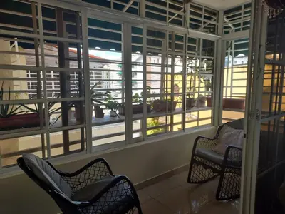 a room with chairs and windows with a view at Central and spacious, 3-bedroom apartment in Santo Domingo in Colorado