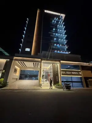a person walking in front of a building at night at Los Corales del Sur- Entire rental unit in Santo Domingo Este, Dominican Republic in Ensanche Savica de Mendoza