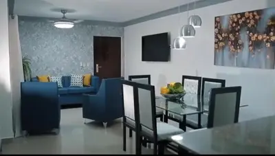 a dining room with a table and a blue couch at Mediterrao santiago in Canabacoa