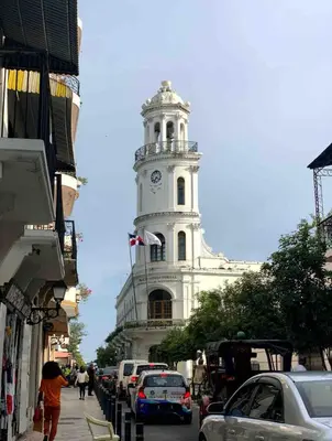 a tall white building with a clock tower on a street at Spacious 3BR Duplex with Private Rooftop , Ideal for Monthly & Corporate Stays in San Isidro