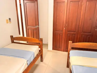 two beds in a room with wooden cabinets at Cozy Huge and Lovely 3 bedrooms apts 2bathdrooms in La Estrella