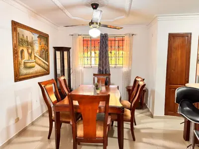 a dining room with a wooden table and chairs at Cozy Huge and Lovely 3 bedrooms apts 2bathdrooms in La Estrella