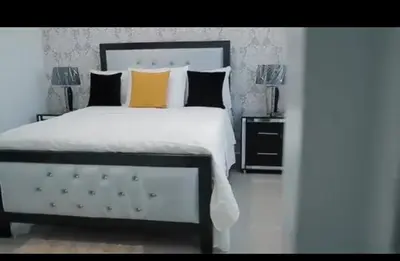 a bedroom with a large white bed with two lamps at Mediterraneo in Canabacoa