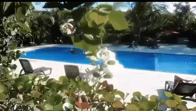 a swimming pool with two chairs and a swimming pool at Mediterraneo in Canabacoa