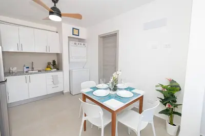 a kitchen and dining room with a table and chairs at Tropical Studio Getaway in Bayahibe in San Rafael del Yuma