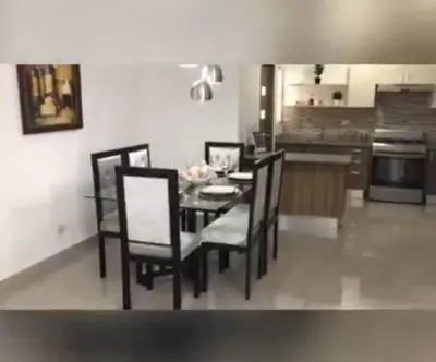 a dining room with a table and chairs in a kitchen at Airbnba304 in Canabacoa
