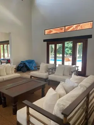 a living room with couches and tables and windows at Residence in Juan Dolió, Guavaberry, is ideal in Los Conucos