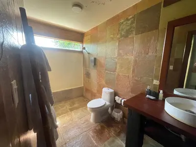 a bathroom with a toilet and a sink and a mirror at Residence in Juan Dolió, Guavaberry, is ideal in Los Conucos
