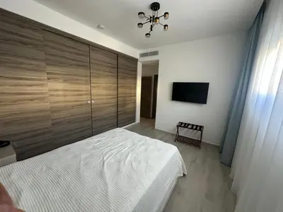 a bedroom with a bed and a large wooden wall at Alexger Beachfront Apartament Bavaro, Punta Cana in Punta Cana