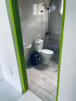 a bathroom with a toilet and a shower in it at Rancho Doña Rita in Higuey