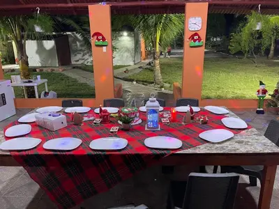 a table with a red table cloth and plates on it at Rancho Doña Rita in Higuey