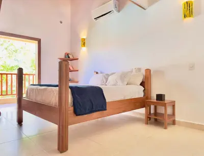 a bedroom with a bed and a balcony at Family Villa Terrenas Samana Near the Beach in Las Terrenas