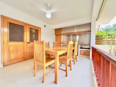 a kitchen with a wooden table and chairs at Family Villa Terrenas Samana Near the Beach in Las Terrenas