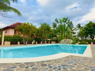 a swimming pool in front of a house with trees at Family Villa Terrenas Samana Near the Beach in Las Terrenas