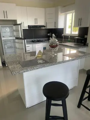 a kitchen with a counter and a black stool at 2 Bdrm 1 Bath Near River and Beach, 3L in Paraíso