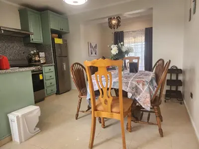 a kitchen with a table and chairs and a kitchen with green cabinets at Apartment-View-Beach-Mountains-Rivers-WiFi-AC-CLB in Santa Cruz de Barahona