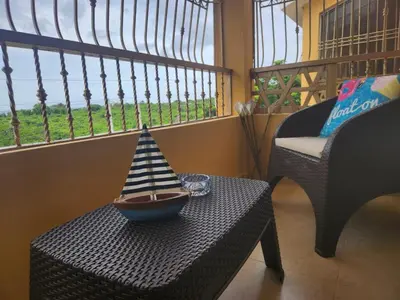 a bowl with a hat on a table with a chair at Apartment-View-Beach-Mountains-Rivers-WiFi-AC-CLB in Santa Cruz de Barahona