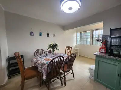 a dining room with a table and chairs and a kitchen at Apartment-View-Beach-Mountains-Rivers-WiFi-AC-CLB in Santa Cruz de Barahona