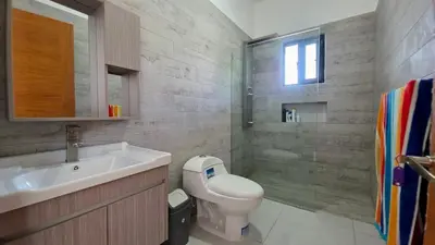 a bathroom with a toilet and a sink and a shower at Ivy Villa Cabarete, fully equipped villa in Cabarete