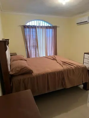 a bedroom with a large bed with a window at Tu escape natural - No incluye bebidas, tiene costo adicional in Miches