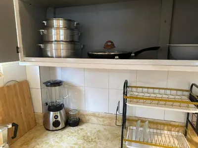 a kitchen with a counter with pots and pans on a shelf at Tu escape natural - No incluye bebidas, tiene costo adicional in Miches