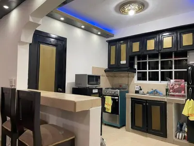 a kitchen with black cabinets and a blue stove at Apartamento a 15 minutos de la playa in Imbert