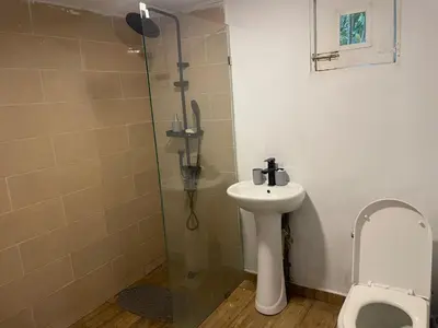 a bathroom with a toilet and a sink and a shower at Dreamvilles Ecovillage in Las Galeras