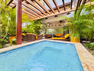 a swimming pool in a house with a pergola at Oceanfront Unit Jacuzzi Balconies of Atlantic in El Limón