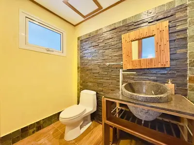 a bathroom with a toilet and a sink at Oceanfront Unit Jacuzzi Balconies of Atlantic in El Limón