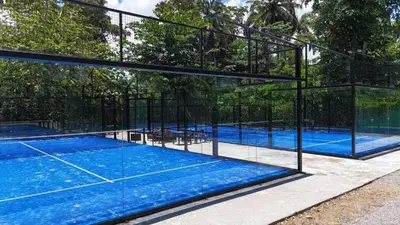 a swimming pool with a tennis court in a building at Oceanfront Unit Jacuzzi Balconies of Atlantic in El Limón