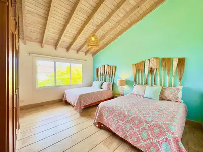 a bedroom with two beds and a window at Oceanfront PH Jacuzzi Balconies of the Atlanti in El Limón