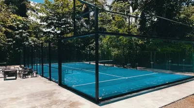 a tennis court with a tennis net on it at Villa 1 min walk from the beach in Las Terranas in El Limón