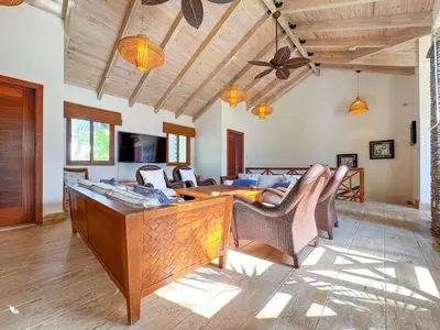 a living room with a table and chairs at Villa 1 min walk from the beach in Las Terranas in El Limón