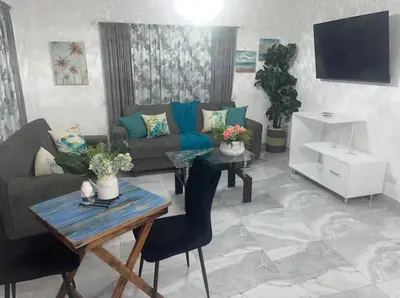 a living room with a couch and a table at Alma Stay Central and cozy in Santa Bárbara de Samaná