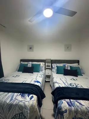 a bedroom with two beds and a ceiling fan at Alma Stay Central and cozy in Santa Bárbara de Samaná