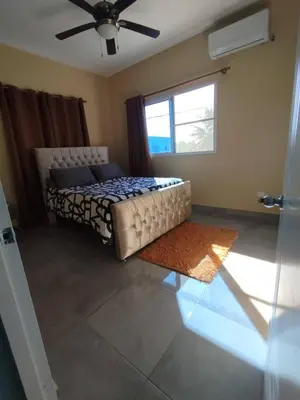 a bedroom with a bed and a ceiling fan at Modern 2BR Piscina BBQ Close To Kite Beach in Cabarete