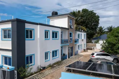 a house with solar panels in front of it at Modern 2BR Piscina BBQ Close To Kite Beach in Cabarete