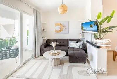 a living room with a couch and a table at Modern Caribbean Stay Coral Azul 301 in La Laguna