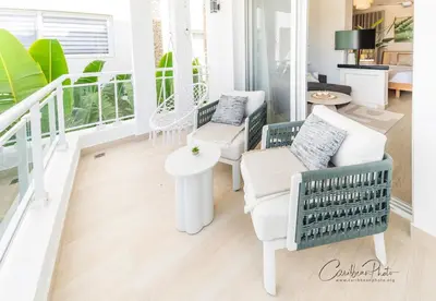 a living room with two chairs and a table at Modern Caribbean Stay Coral Azul 301 in La Laguna