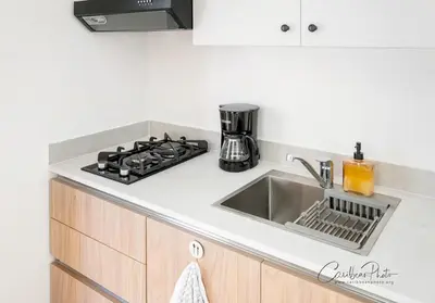a kitchen counter with a sink and a stove at Modern Caribbean Stay Coral Azul 301 in La Laguna