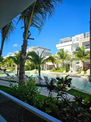 a resort with a swimming pool and palm trees at Aqua Esmeralda Beachfront Apartment Trinidad 103 in La Laguna
