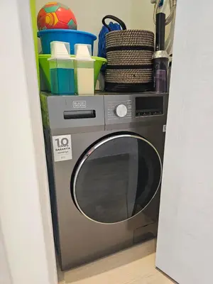 a silver washing machine sitting in a room at Aqua Esmeralda Beachfront Apartment Trinidad 103 in La Laguna
