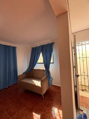a living room with a couch and a window at Beautiful Quiet shared home in Santo Domingo