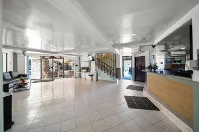 a large room with a tile floor and a hallway at Cheap Hotel Room in Sosua Center in Sosúa