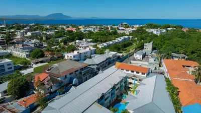 an aerial view of a city with buildings and the ocean at Cheap Hotel Room in Sosua Center in Sosúa