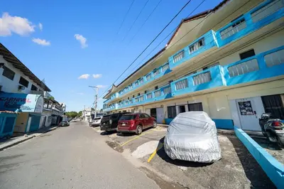 a building with a tent parked in a parking lot at Cheap Hotel Room in Sosua Strip in Sosúa
