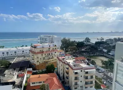 a city with buildings and the ocean in the background at Majestic 2Bd Ocean view Apartment Boca Del Mar III in Boca Chica
