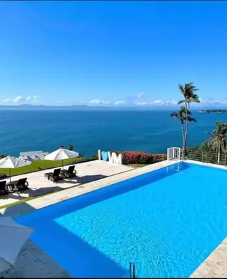 a swimming pool with a view of the ocean at Spectacular Ocean View 1-Bedroom Condo, Vista Mare, Samana, DR in Villa Ramfis